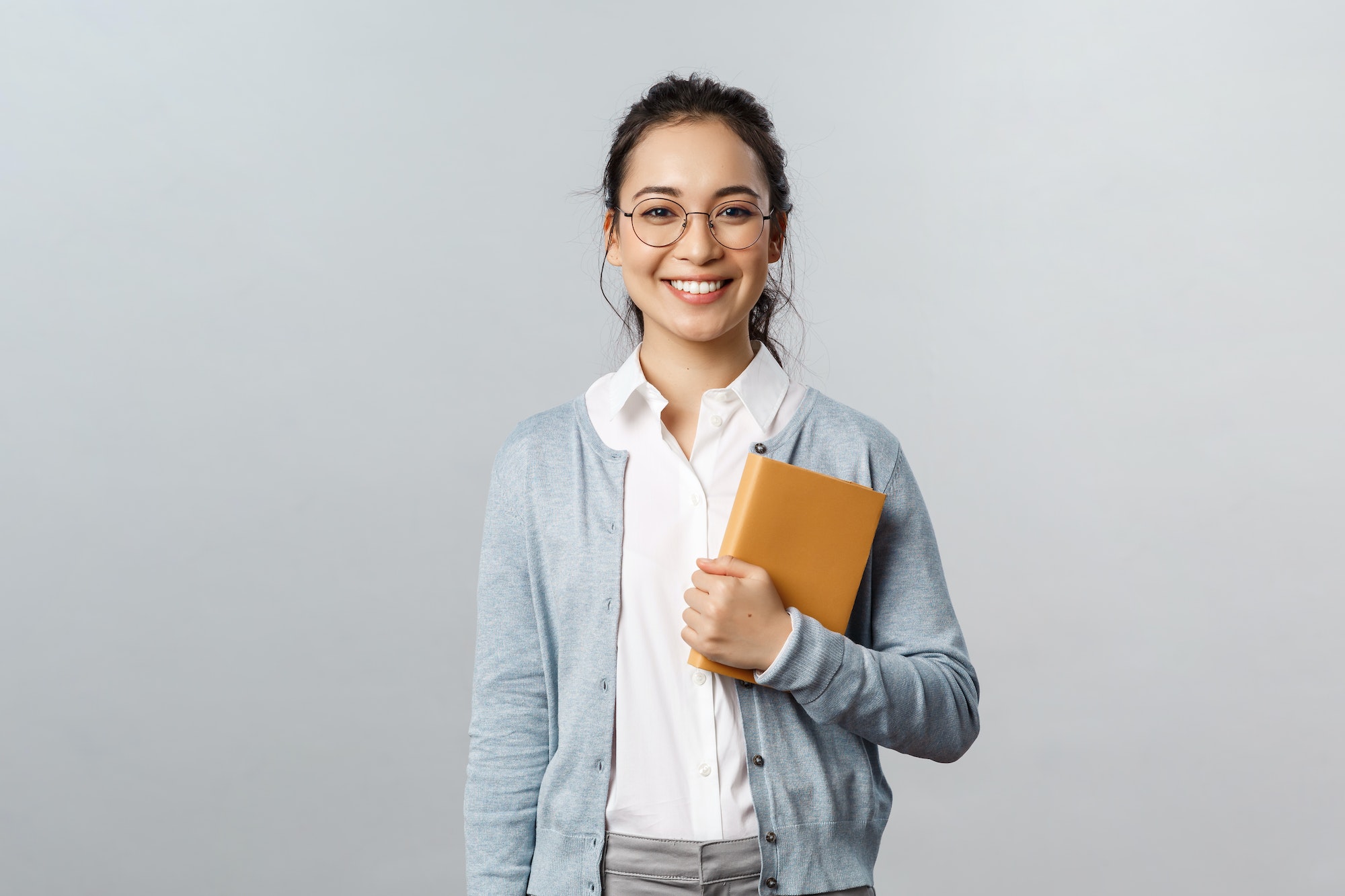 Education, teachers, university and schools concept. Young smiling woman, employer or student in Education, teachers, university and schools concept. Young smiling woman, employer or student in